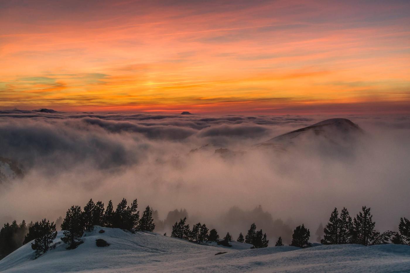 Pyrenees mountains between fog at sunset